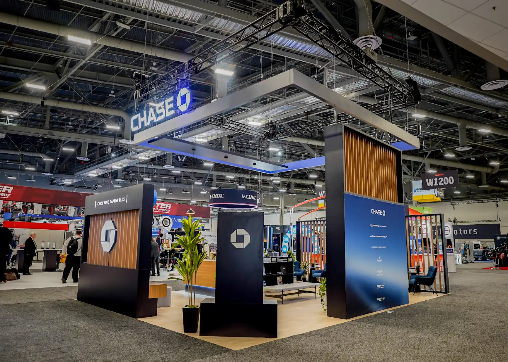 Hospitality bar and seating zone inside the Chase Auto booth at NADA Show 2026 with branded countertops