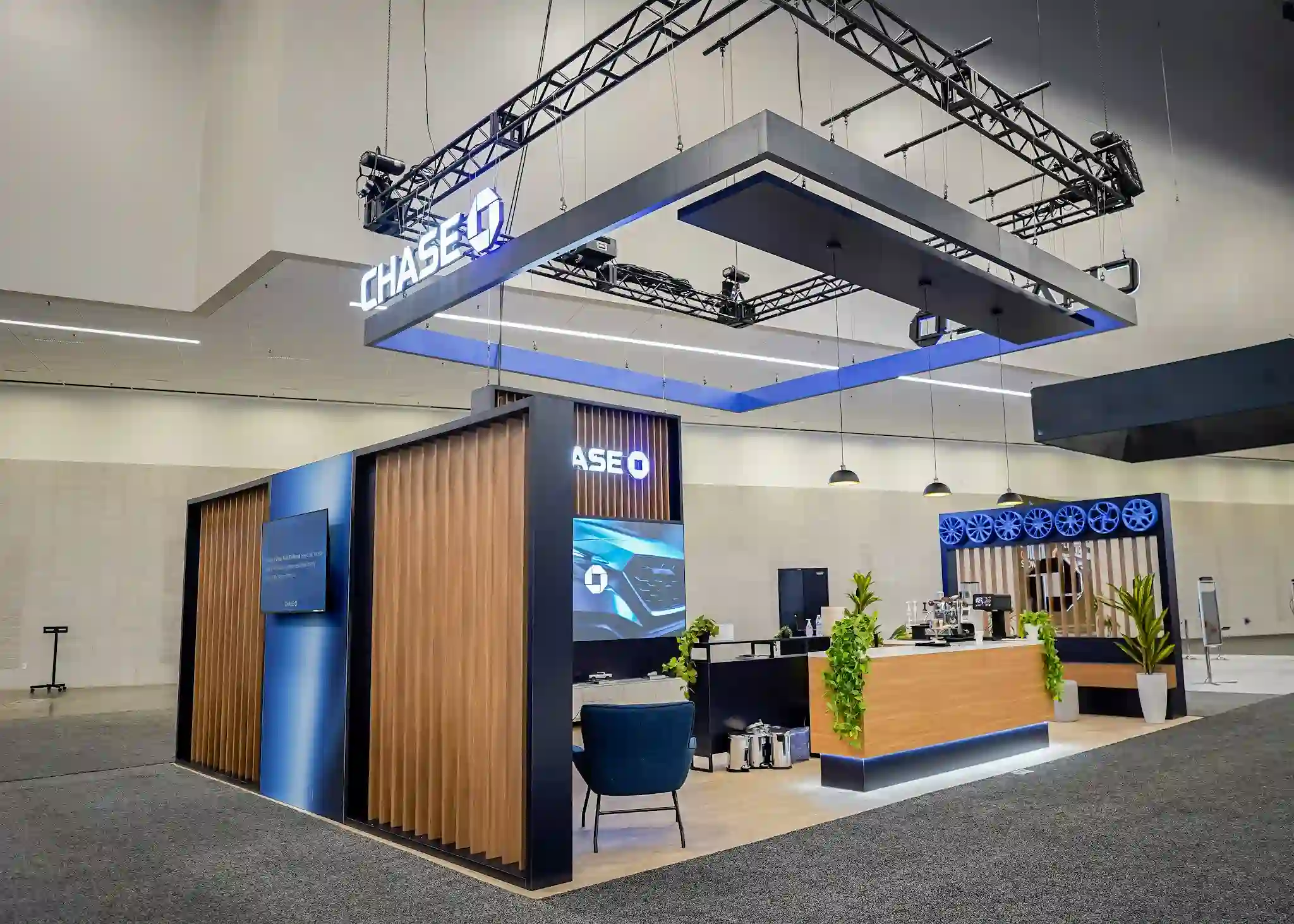 Chase Auto booth hospitality bar with branded countertops, coffee service station, and ambient lighting