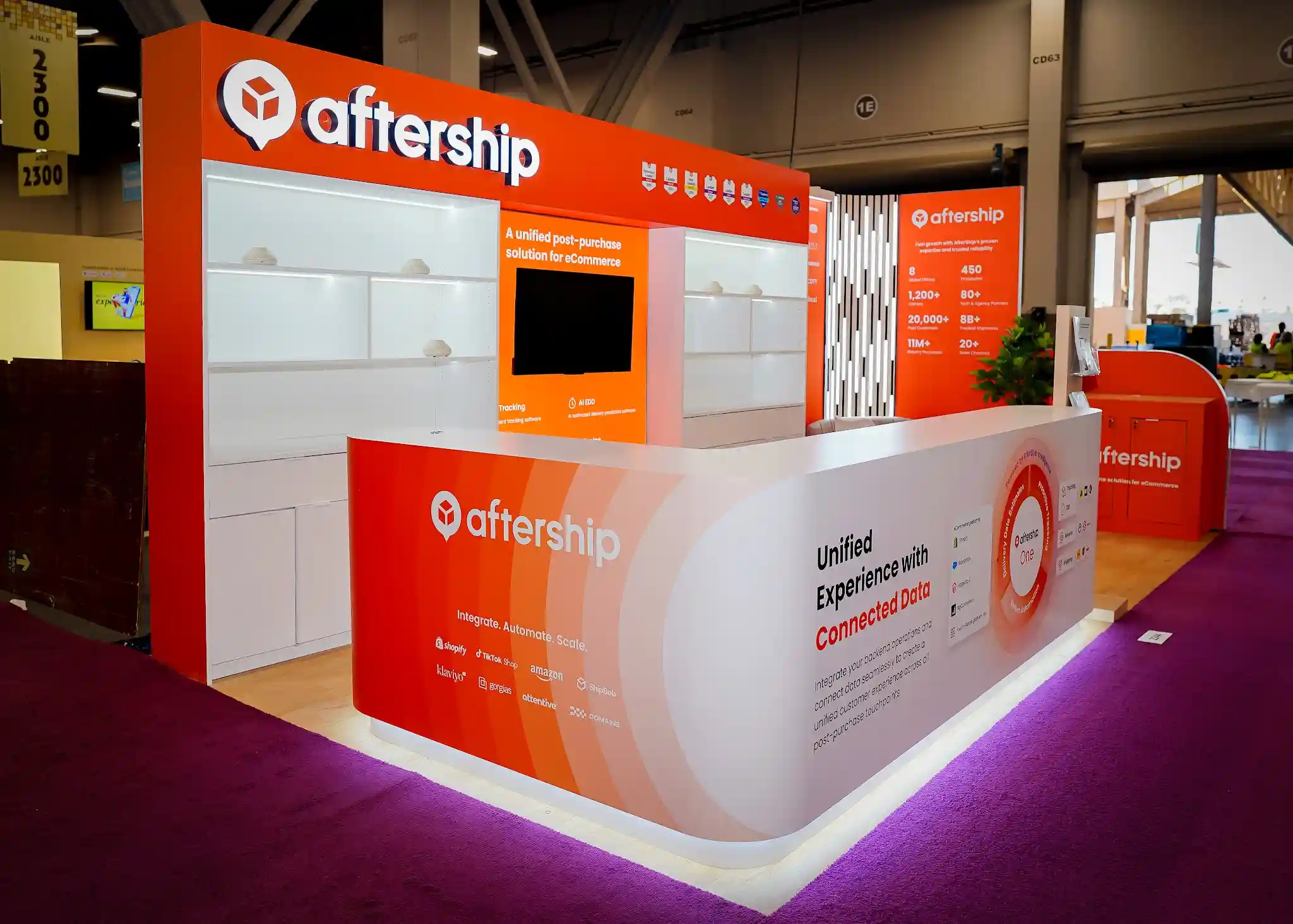 Exhibitor reviewing trade show exhibit vendor proposals with booth design renderings on a conference table Exhibitor reviewing trade show exhibit vendor proposals with booth design renderings on a conference table