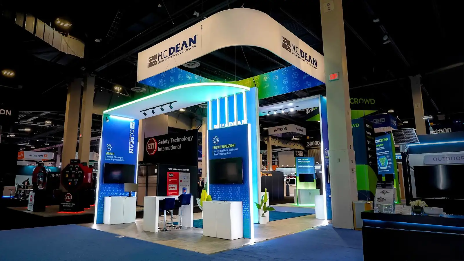 Bold, branded trade show booth interior with immersive lighting, large graphic panels, and engaged visitors Bold, branded trade show booth interior with immersive lighting, large graphic panels, and engaged visitors