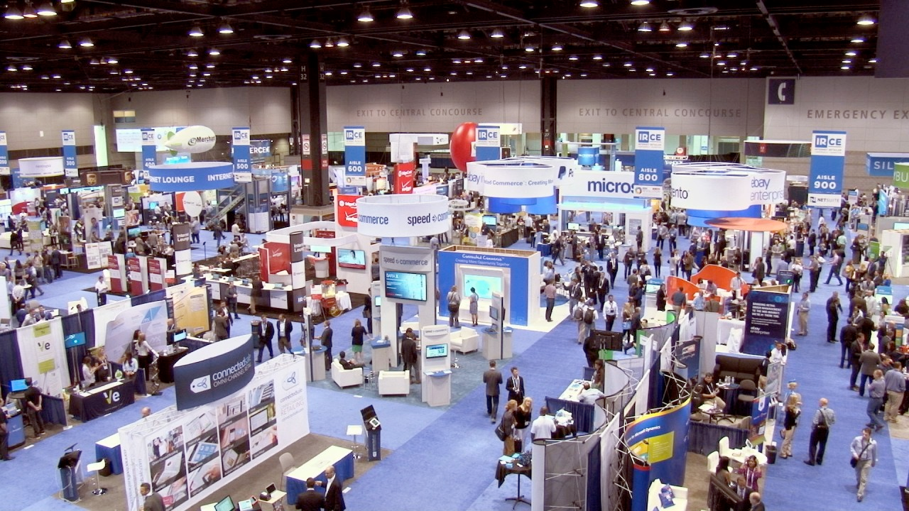 trade show vendor — exhibitor reviewing vendor contracts and trade show planning documents at desk before Las Vegas convention