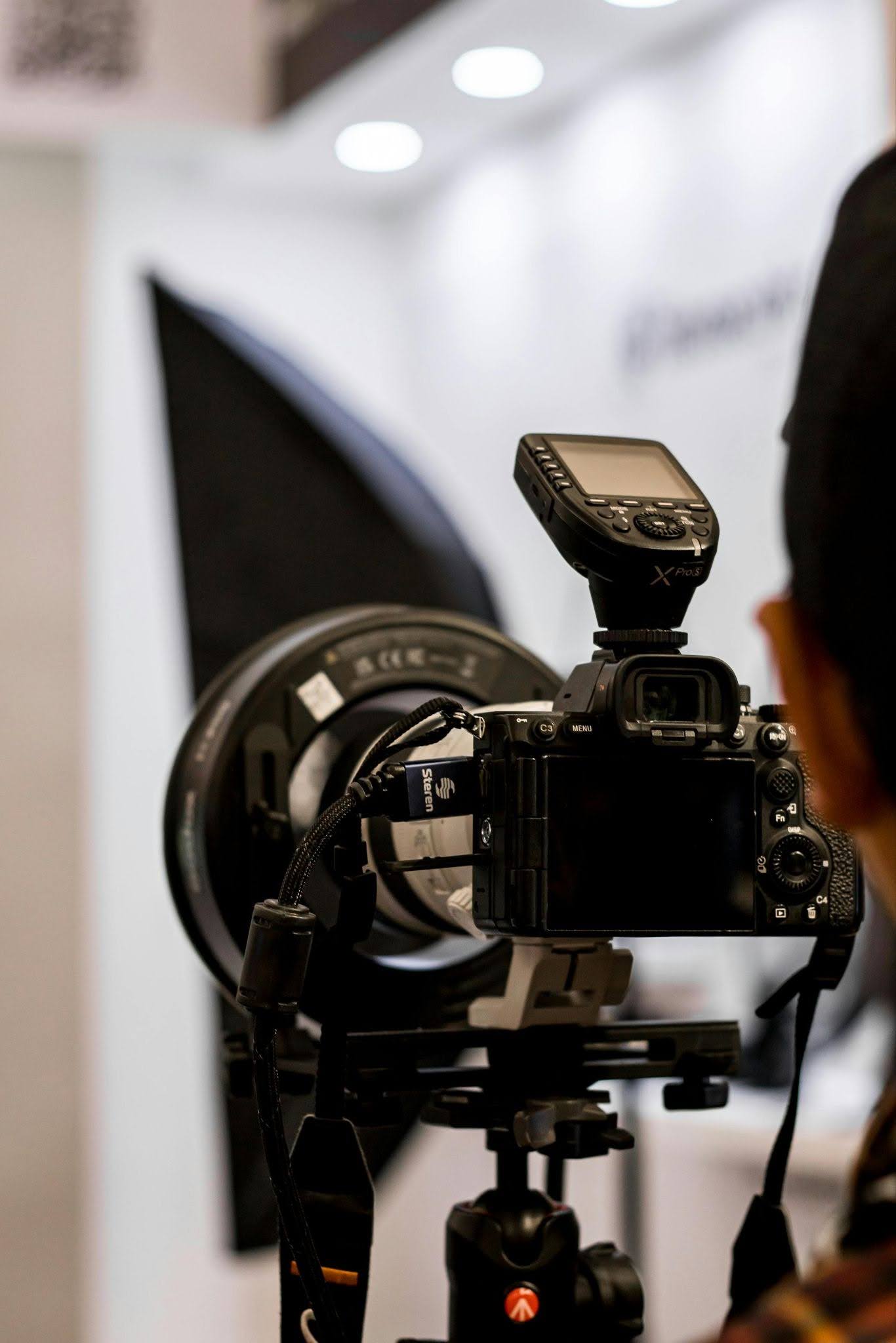 Professional photographer capturing a busy trade show booth during peak floor hours Professional photographer capturing a busy trade show booth during peak floor hours