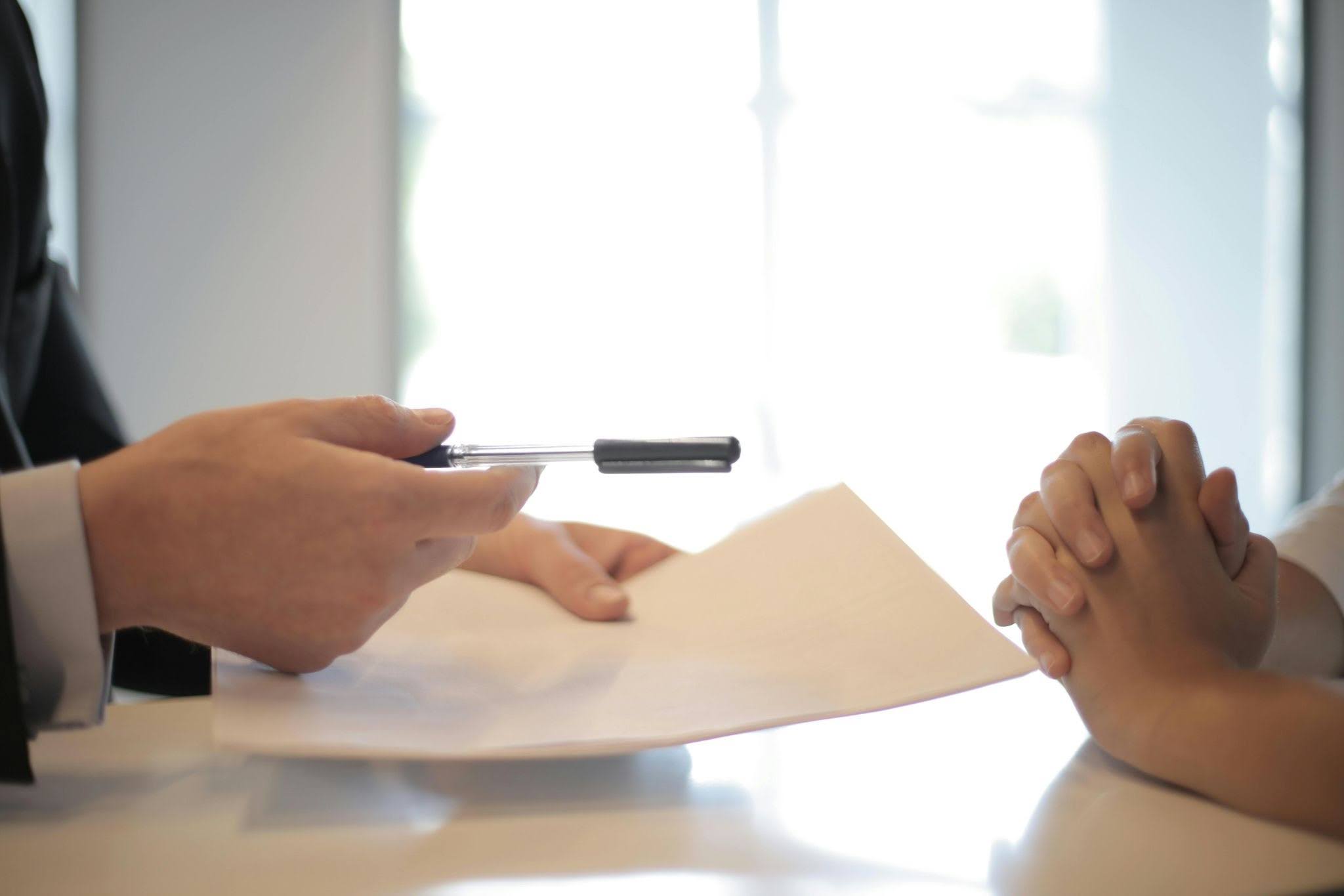 Exhibitor reviewing insurance documentation at a trade show setup area Exhibitor reviewing insurance documentation at a trade show setup area
