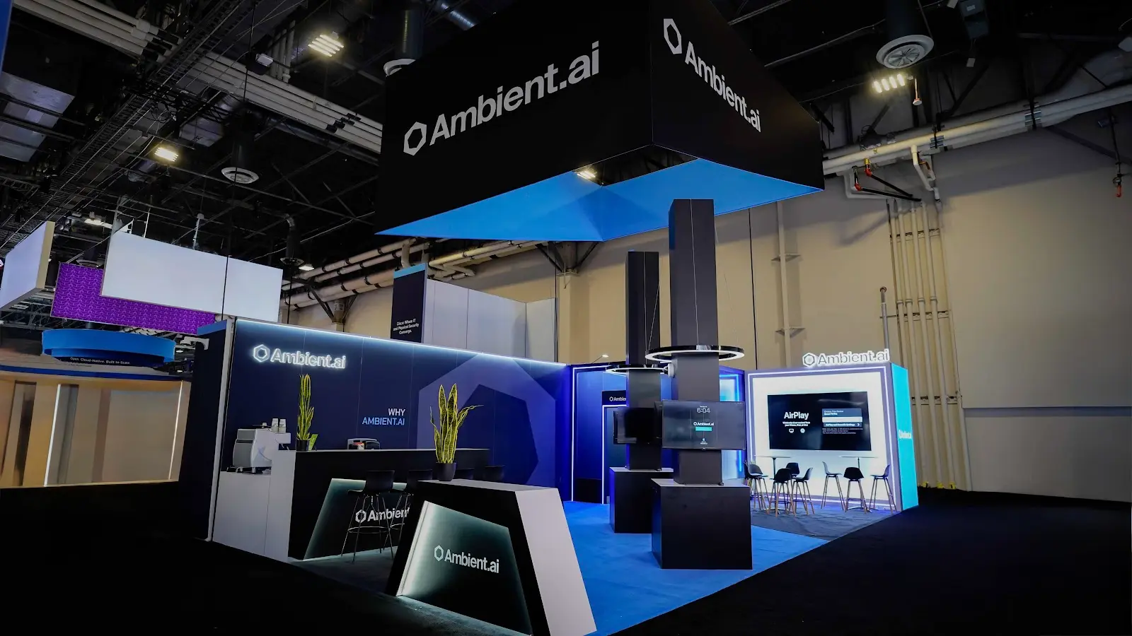 Ambient.ai 20x40 black and blue custom island booth at ISC West 2026, seen from the aisle at The Venetian Expo in Las Vegas