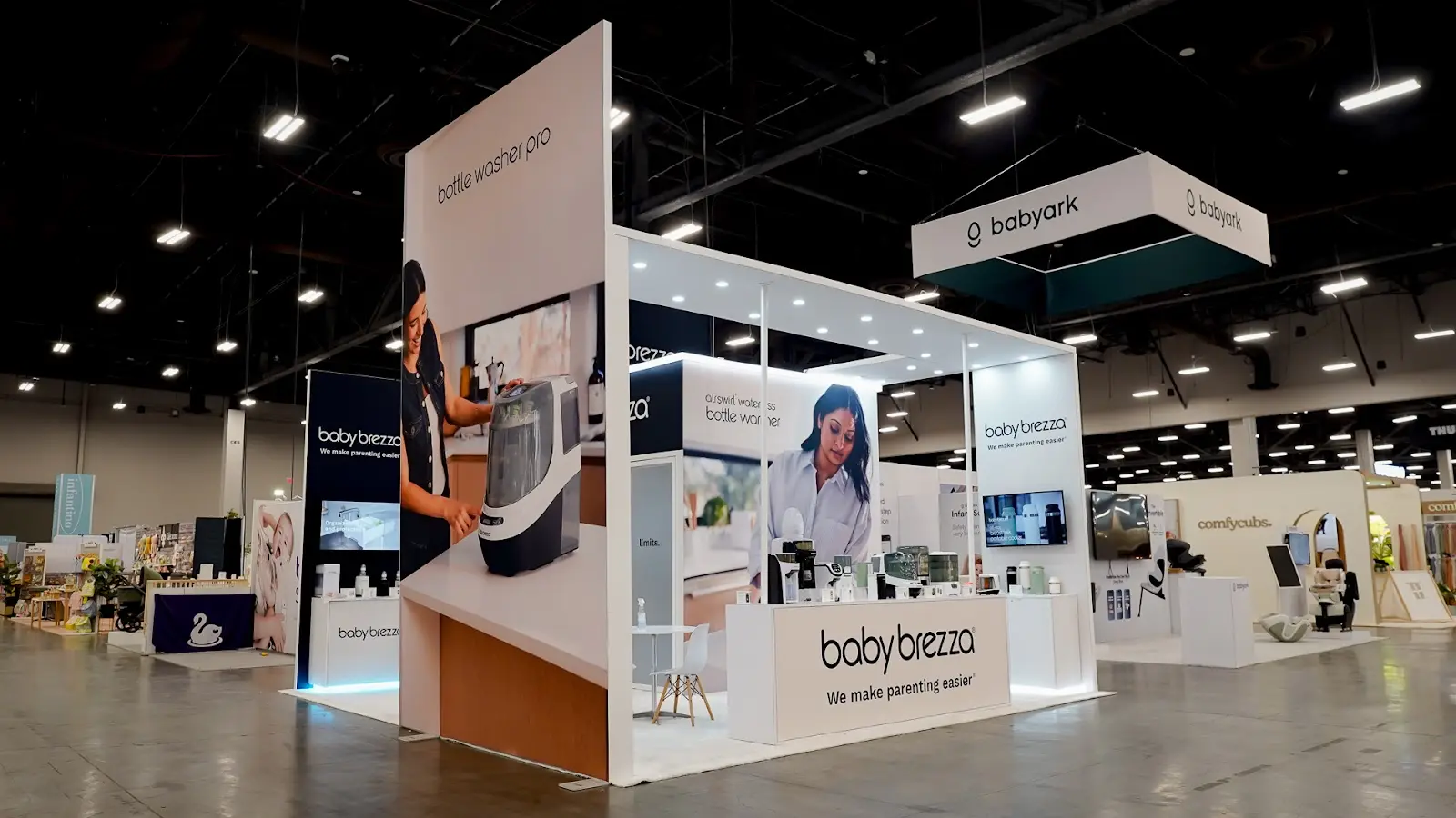 Baby Brezza modern island booth structure at ABC Kids Expo 2026, showing the enclosed room-like layout of the exhibit