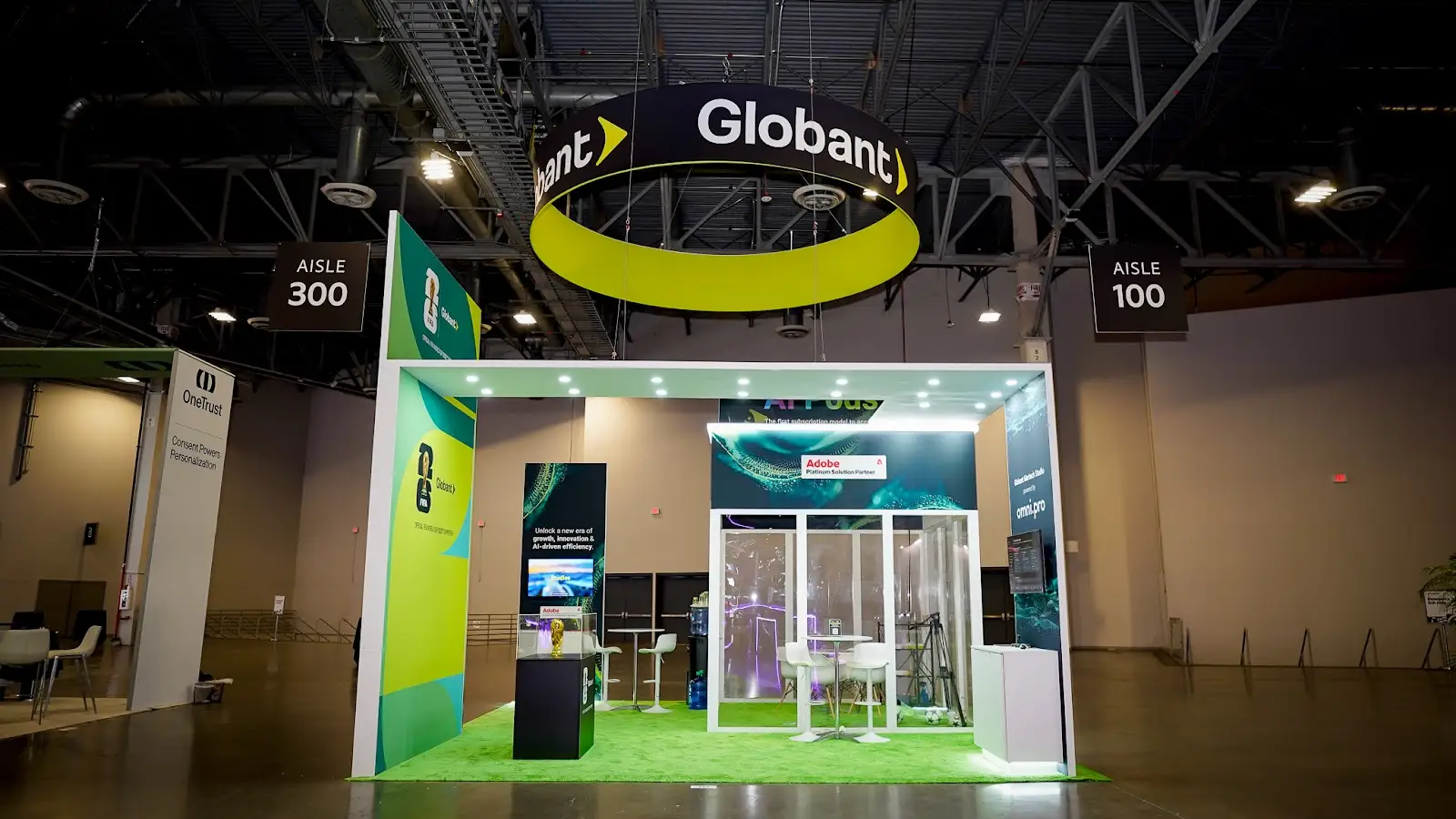 Globant custom booth at Adobe Summit 2026 showing Adobe partner branding integrated into the exhibit structure alongside Globant's own identity