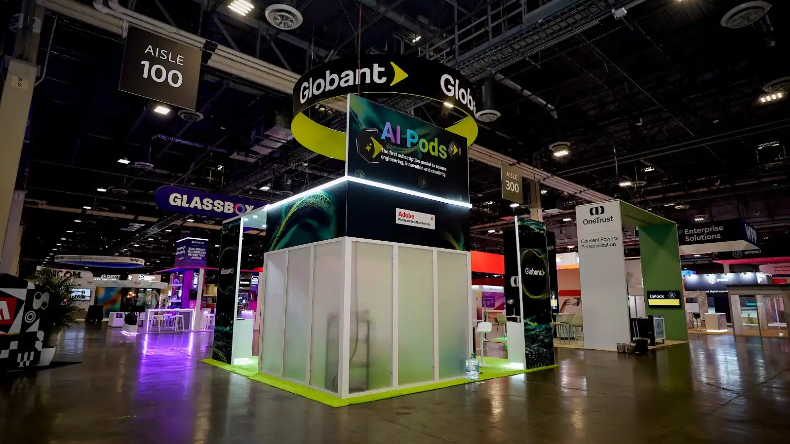 AI demonstration pods inside the Globant island booth at Adobe Summit 2026, arranged as individual working stations across the exhibit floor