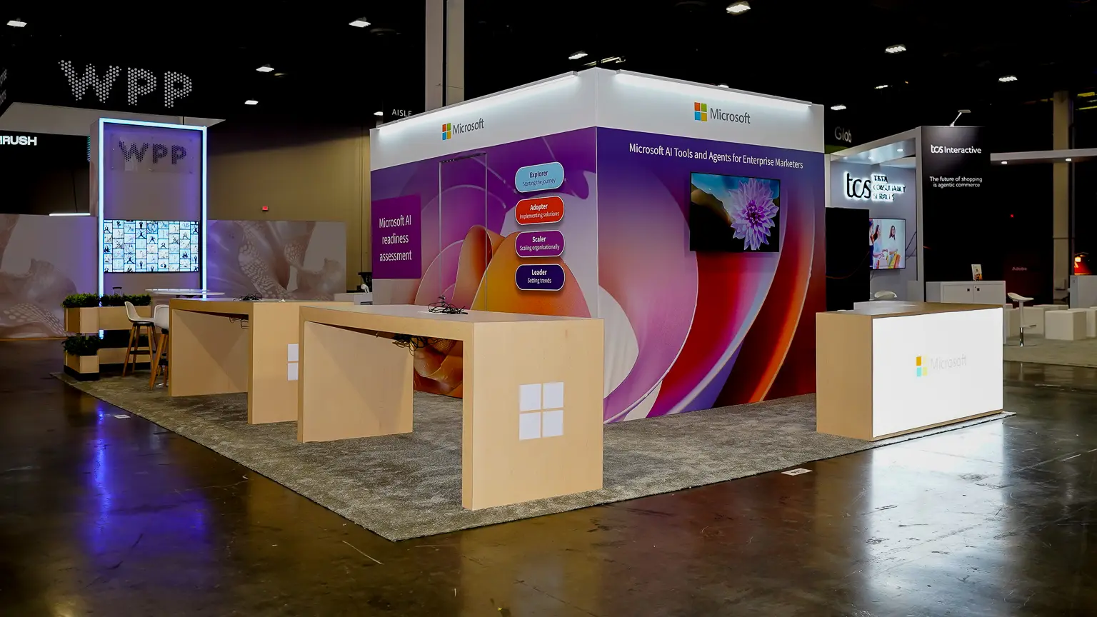 Microsoft booth at Adobe Summit 2026 with AI agent messaging on the exhibit graphics, positioned to face the aisle at the Venetian Expo