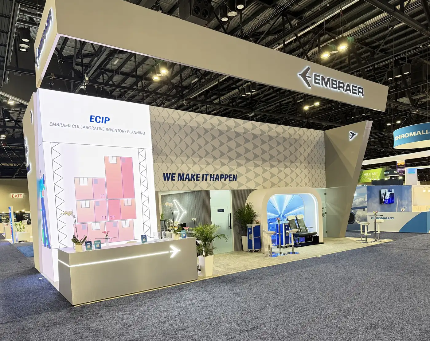 Reception counter and ECIP Collaborative Inventory Planning LED wall at the Embraer booth, MRO Americas 2026