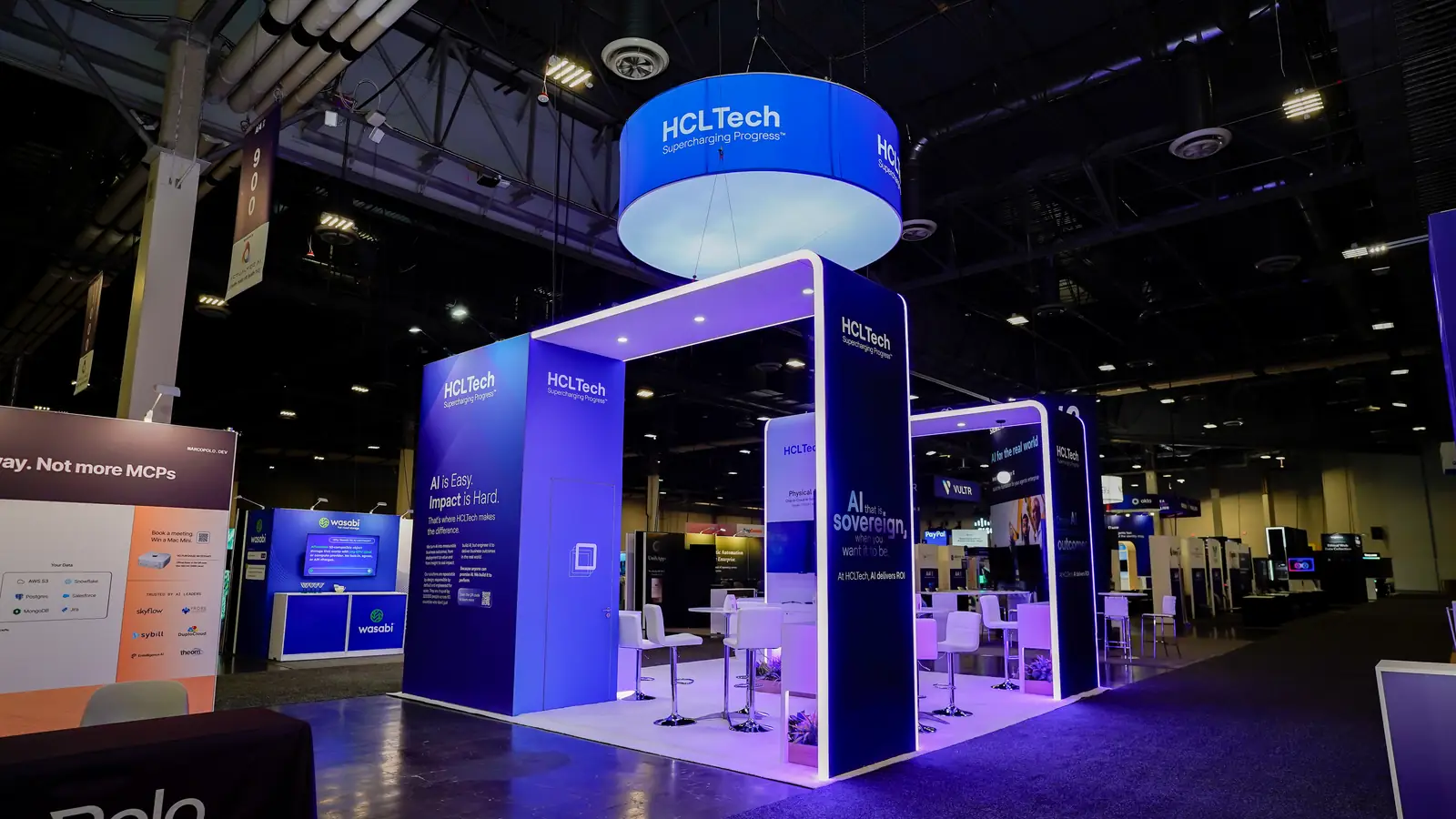 Corner view of the HCLTech Ai4 2026 booth showing the archway structure framing the open floor plan