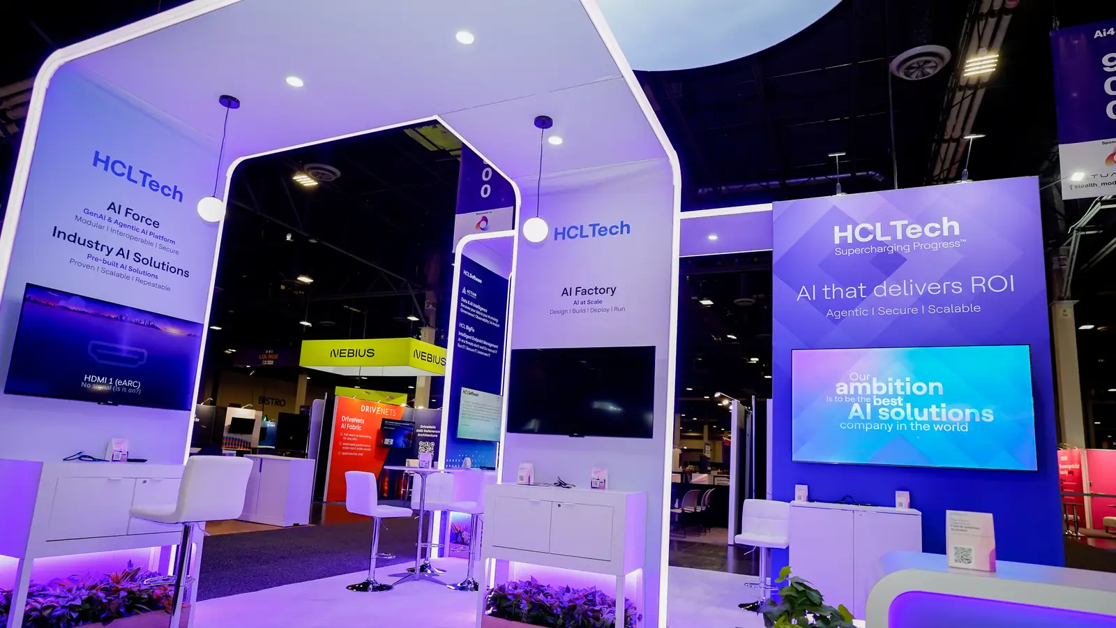 Demo stations inside the HCLTech booth at Ai4 2026 with screens and consultation counters