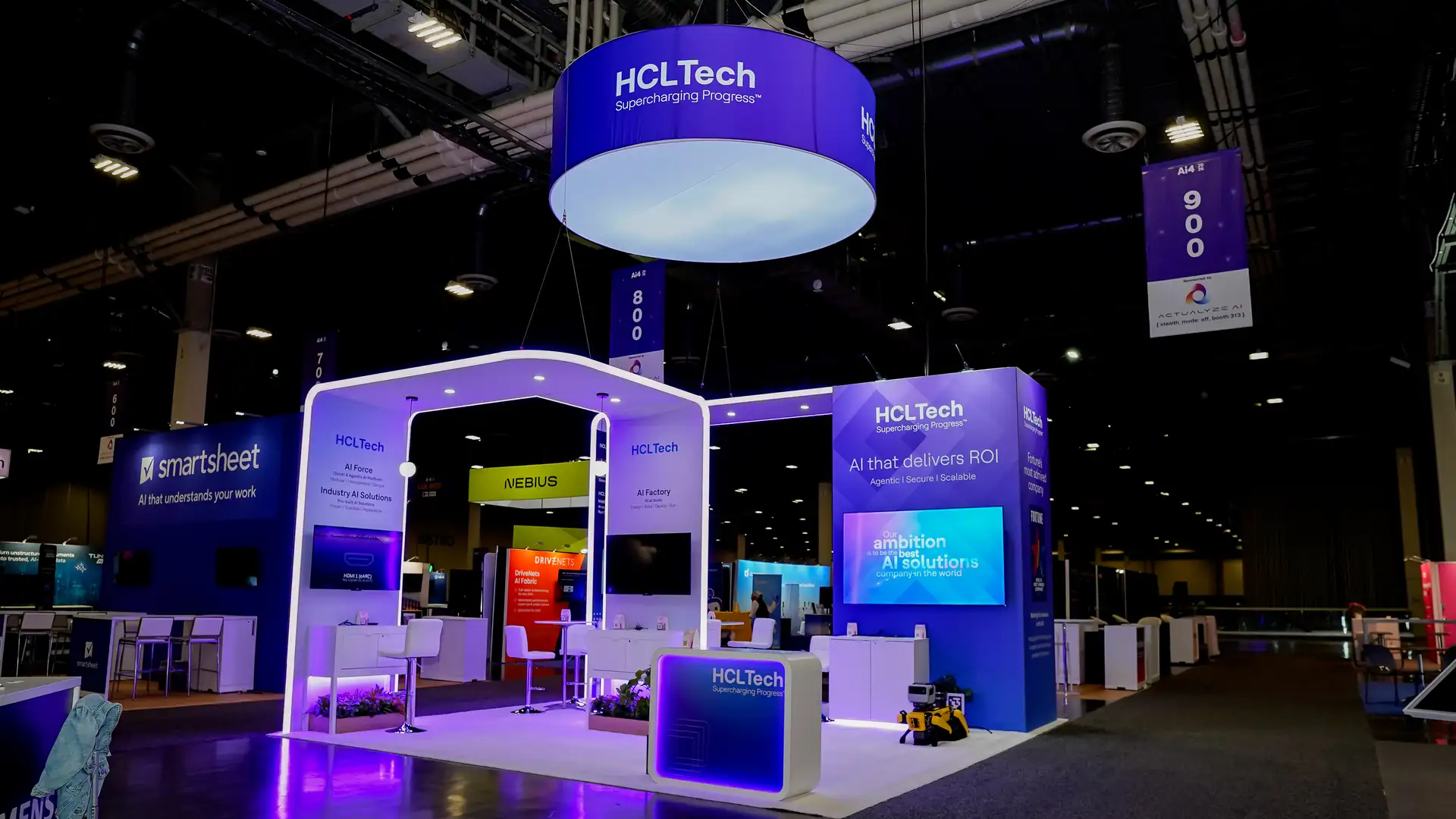 Front elevation of the HCLTech custom island booth at Ai4 2026 in The Venetian, Las Vegas, with archway canopy and branded tower