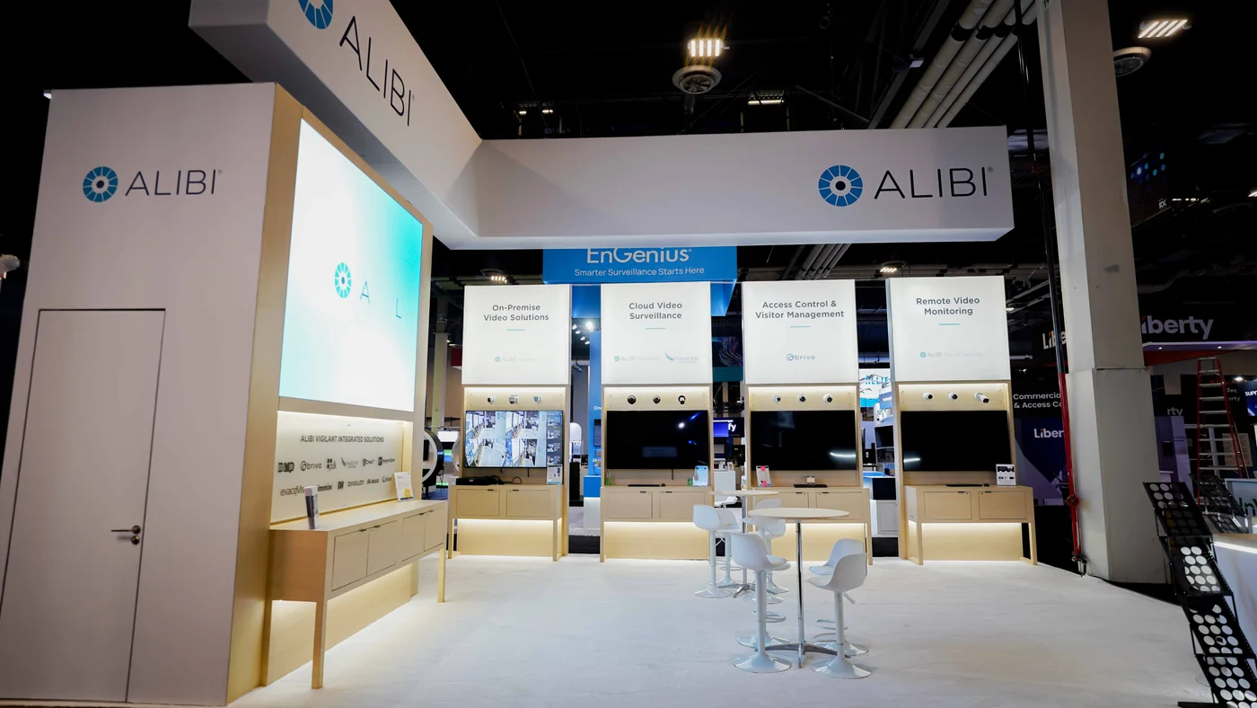 Straight-on interior elevation of the Alibi Security 20x30 booth at ISC West 2026 with the LED wall on the left and four backlit solution stations for On-Premise Video, Cloud Video Surveillance, Access Control and Remote Video Monitoring