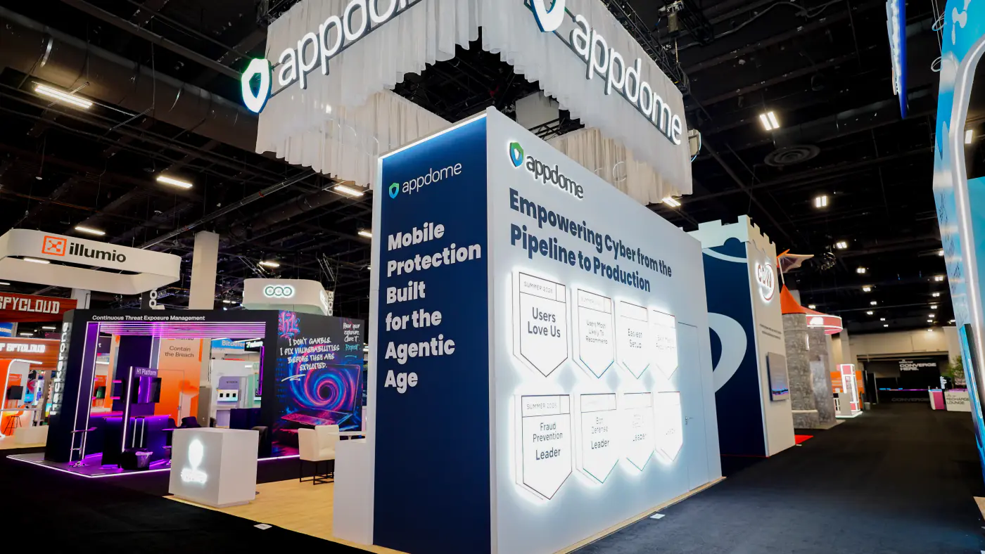 Corner of the Appdome booth at Black Hat USA 2026 with a backlit wall of eight G2 Summer 2026 badges including Users Love Us and Fraud Prevention Leader