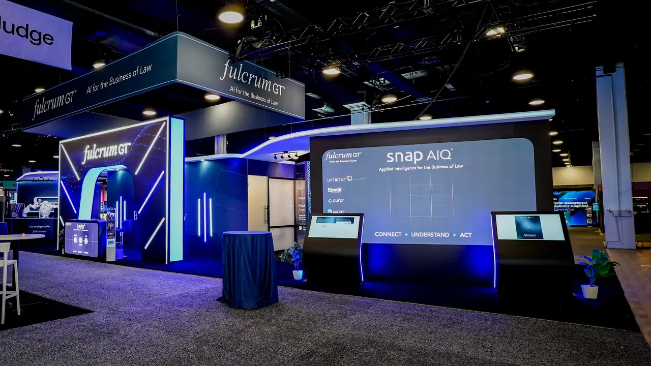 LED wall inside the Fulcrum GT booth at ILTACON 2026 showing Snap and AIQ product messaging