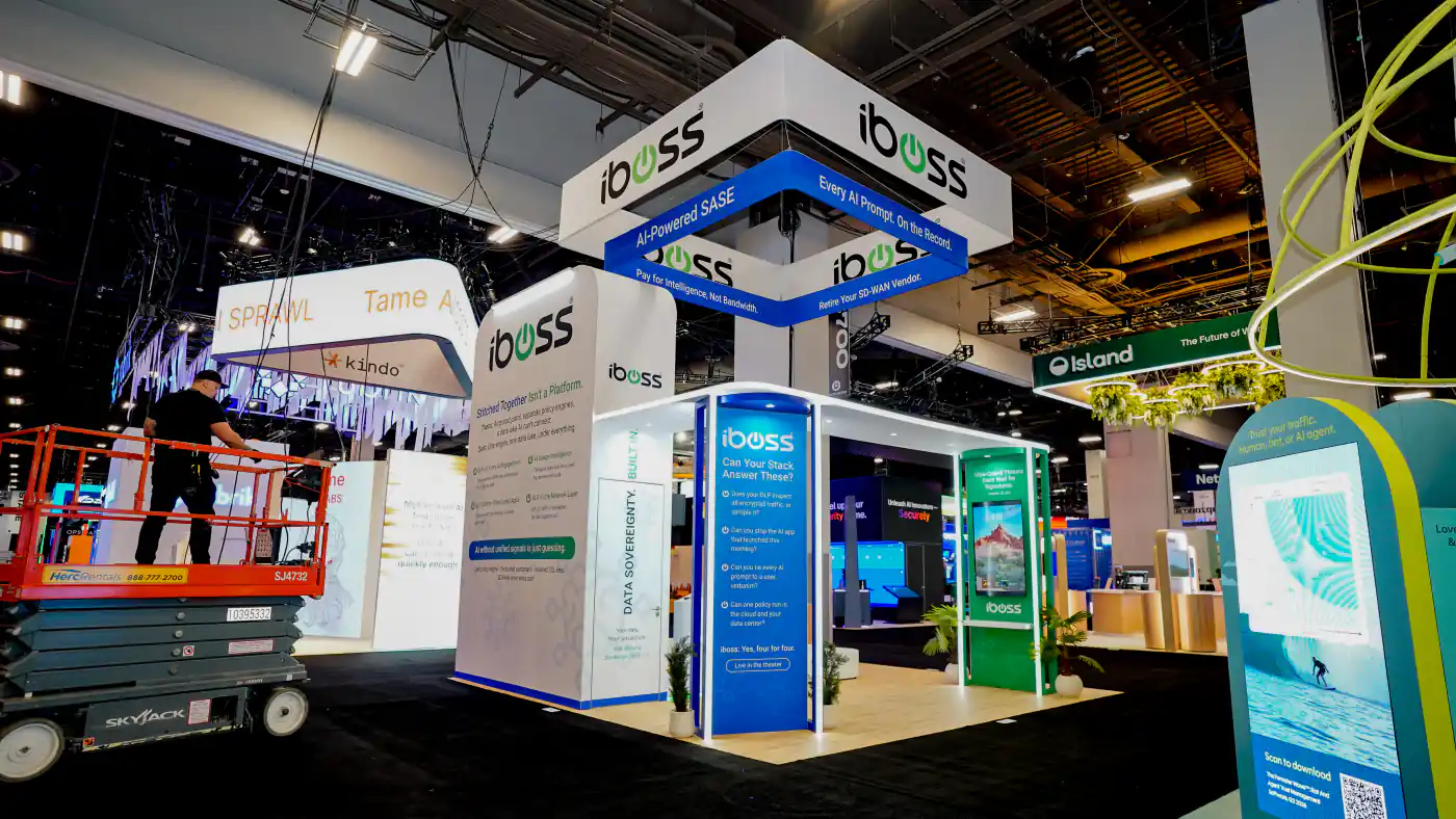 Corner view of the iboss AI-Powered SASE booth at Black Hat USA 2026 showing the Can Your Stack Answer These pillar, green Vibe-Coded Threats kiosk and Stitched Together Isn't a Platform wall
