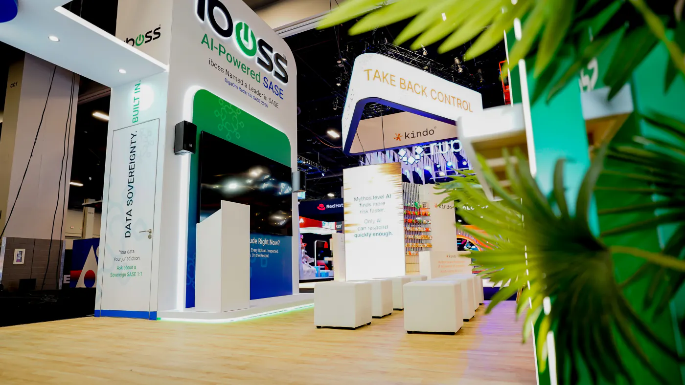 Low-angle view of the iboss booth theater at Black Hat USA 2026 with GigaOm Leader in SASE headline, presenter lectern, screen wall and white cube seating