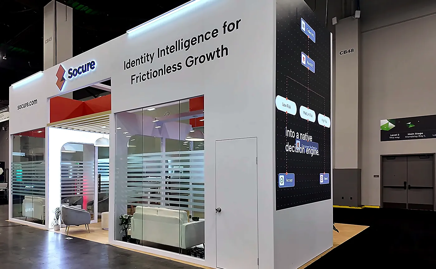 Right side of the Socure 20x30 booth at Fintech Meetup 2026 showing the Identity Intelligence for Frictionless Growth header, slatted privacy walls and lounge seating