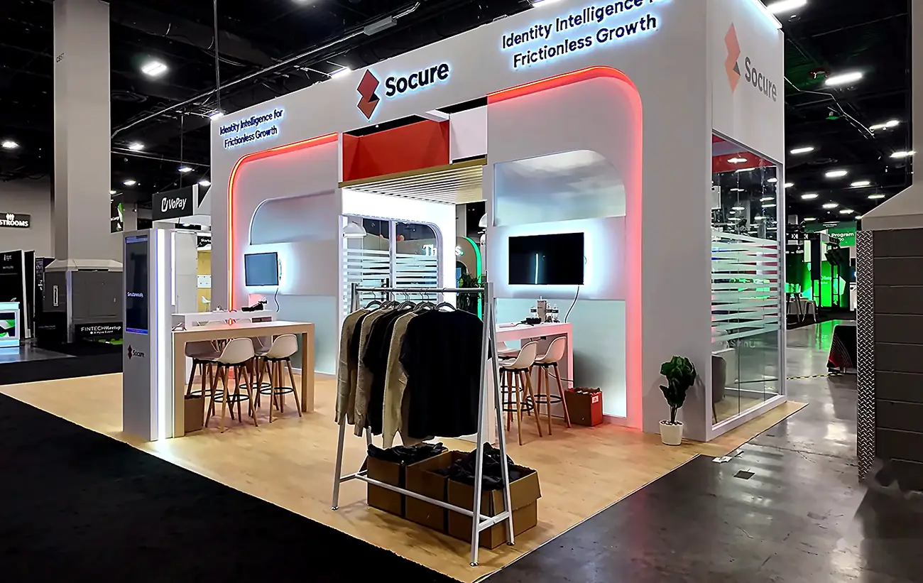 Wide view of the Socure 20x30 booth at Fintech Meetup 2026 from the left side of the show floor showing the full structure and meeting area