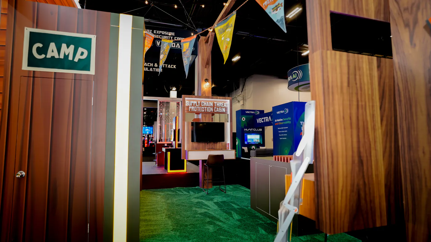 View through the Camp SpyCloud booth past the Camp door to the Supply Chain Threat Protection Cabin demo station
